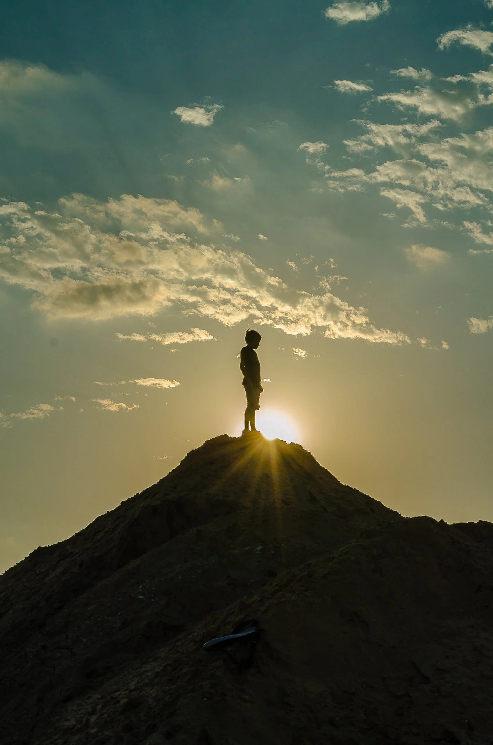person on mountain top. sunset